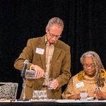 Two faculty members getting refreshments
